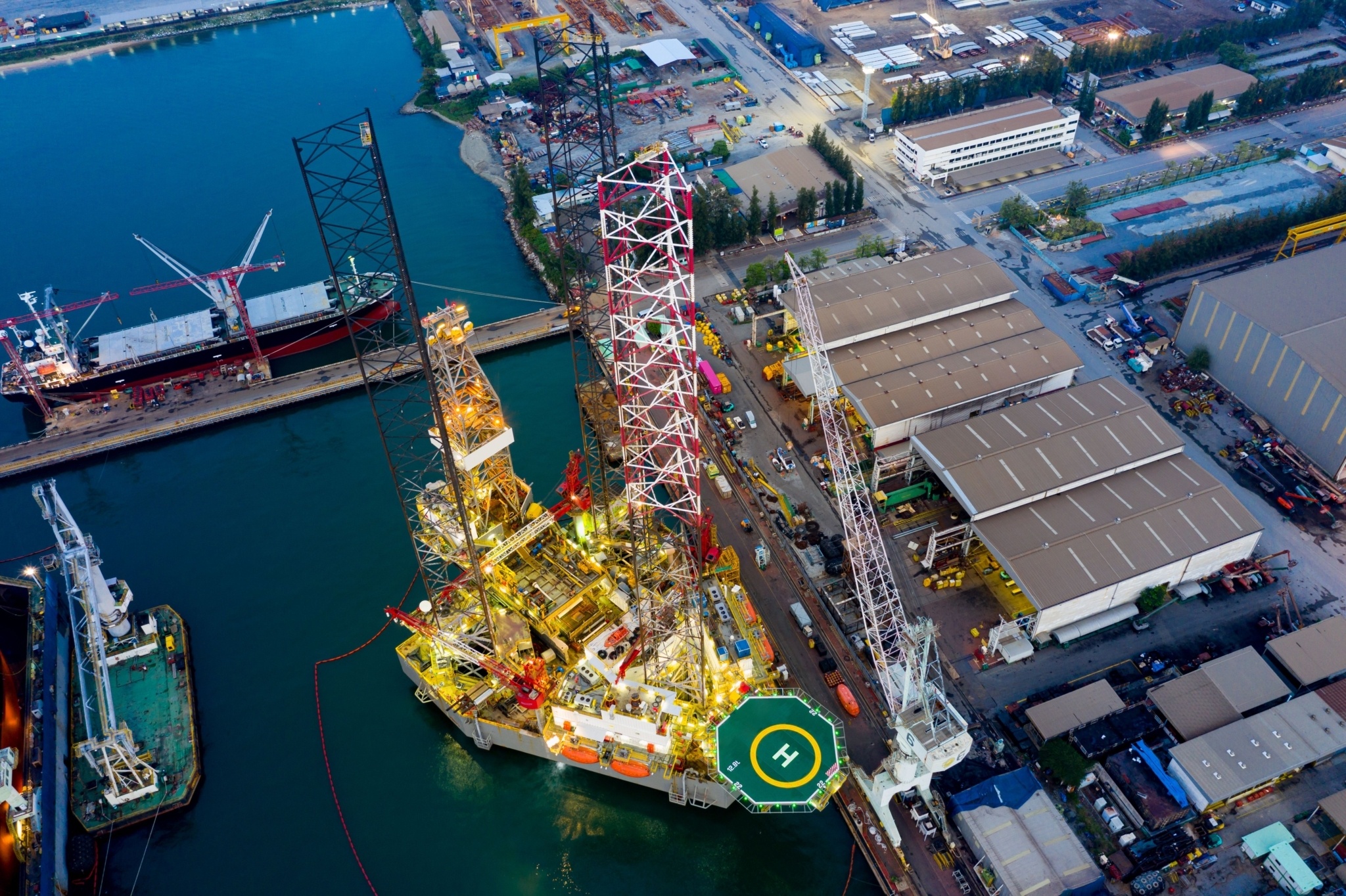 A jack-up rig in the shipyard at sunset