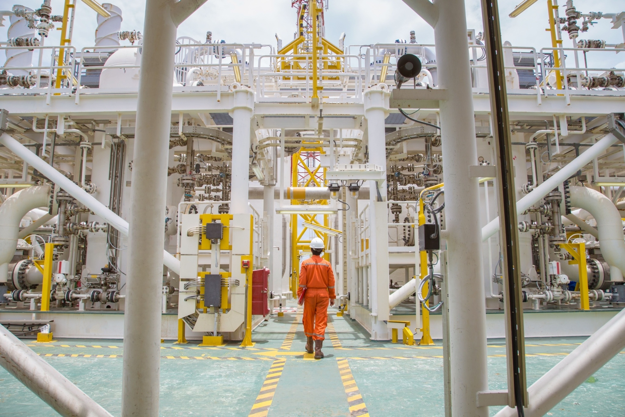 Oil rig worker walking on platform